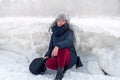 Woman on the background of a winter landscape with large hummocks, frozen ice, Jurmala, Latvia. Winter walk.