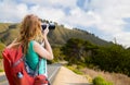 Woman with backpack and camera at big sur coast Royalty Free Stock Photo