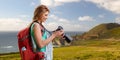 Woman with backpack and camera at big sur coast Royalty Free Stock Photo