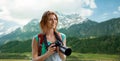 Woman with backpack and camera over mountains Royalty Free Stock Photo