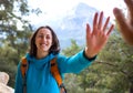 A woman with a backpack gives five to a friend Royalty Free Stock Photo