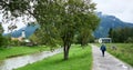 A female backpacker walks a nice trail along the Ammer River in Bavaria, Germany