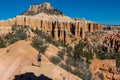 Woman with backpack hiking on Fairyland Loop trail with scenic view of Boat Mesa sandstone rock formations in Bryce Canyon Royalty Free Stock Photo