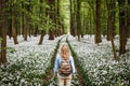 Woman with backpack hiking on footpath in forest Royalty Free Stock Photo