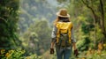 Woman with backpack hiking on a footpath in tropical forest. Solo female tourist outdoors