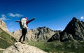 woman with backpack hiking on high altitude mountain top Royalty Free Stock Photo