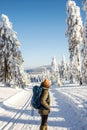 Woman with backpack hiking in winter mountains at trekking trail Royalty Free Stock Photo