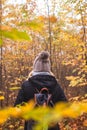 Woman with backpack and knit hat hiking in foggy forest Royalty Free Stock Photo