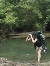 Woman With Backpack Looking Through Binoculars