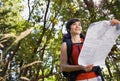 Woman with backpack and map