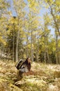 Woman With Backpack Resting In Forest