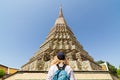 Woman with backpack standing in front of Giant stupa at Wat Pho Reclining Buddha temple complex in Bangkok, Thailand Royalty Free Stock Photo