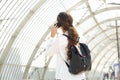 Woman with backpack talking on cellphone