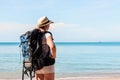 A woman with a backpack on an uninhabited island waited