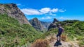 Woman with backpack watching volcanic rock formations in Garajonay National Park seen from Roque de Agando, La Gomera