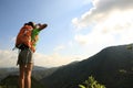 Woman backpack yelling at mountain peak Royalty Free Stock Photo