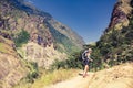 Woman backpacker climbing with backpack in Himalayas, Nepal