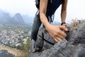 Woman backpacker climbing rock on mountain top Royalty Free Stock Photo