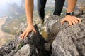 Woman backpacker climbing rock to the mountain top Royalty Free Stock Photo