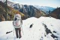 Woman backpacker with dog hiking winter mountains Royalty Free Stock Photo