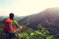 Woman backpacker enjoy the view at mountain peak Royalty Free Stock Photo