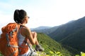 Woman backpacker enjoy the view at mountain peak Royalty Free Stock Photo