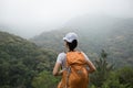 Backpacker enjoying the view on morning mountain valley