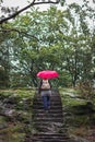 Woman with red umbrella walking at mountain hill Royalty Free Stock Photo