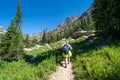 Woman backpacker hikes along the Cascade Canyon trail in Grand Teton National Park Royalty Free Stock Photo