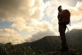 Woman backpacker hiking on mountain peak