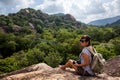 Woman backpacker and photo camera hiking in the mountain peak Royalty Free Stock Photo