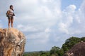 Woman backpacker and photo camera hiking in the mountain peak Royalty Free Stock Photo