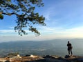 Woman backpacker standing on the mountain top