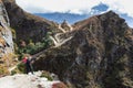 Woman backpacker standing mountain trail near buddhist stupa. Royalty Free Stock Photo