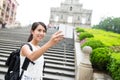 Woman backpacker taking selfie by digital camera Royalty Free Stock Photo