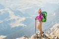 woman backpacker tourist standing on a top of the mountain ridge Royalty Free Stock Photo