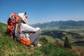 Woman backpacker traveler sitis on the mountain hill with beautiful view on valley