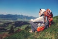 Woman backpacker traveler sitis on the mountain hill with beautiful view on valley