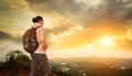 Woman backpacker traveling with backpack standing on top of the Royalty Free Stock Photo