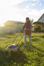 Woman in backyard mowing grass lawn mower Royalty Free Stock Photo