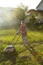 Woman in backyard mowing grass lawn mower Royalty Free Stock Photo