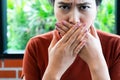 Woman with bad breath covering mouth, halitosis concept Royalty Free Stock Photo