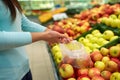 Woman with bag buying apples at grocery store Royalty Free Stock Photo