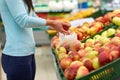 Woman with bag buying apples at grocery store Royalty Free Stock Photo