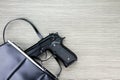 Woman bag with gun hidden, Handgun falling from a woman`s purse. Royalty Free Stock Photo