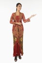 Woman in baju kebaya with welcoming hand gesture. Conceptual image