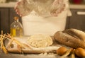 Woman baker hands, kneads dough and making bread, butter, tomato flour Royalty Free Stock Photo