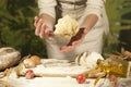 Woman baker hands,pizza kneads dough and making housework making bread, butter, tomato flour Royalty Free Stock Photo