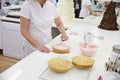 Woman In Bakery Decorating Cake With Icing Royalty Free Stock Photo