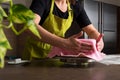 Woman in bakery decorating heart shaped cake with royal icing